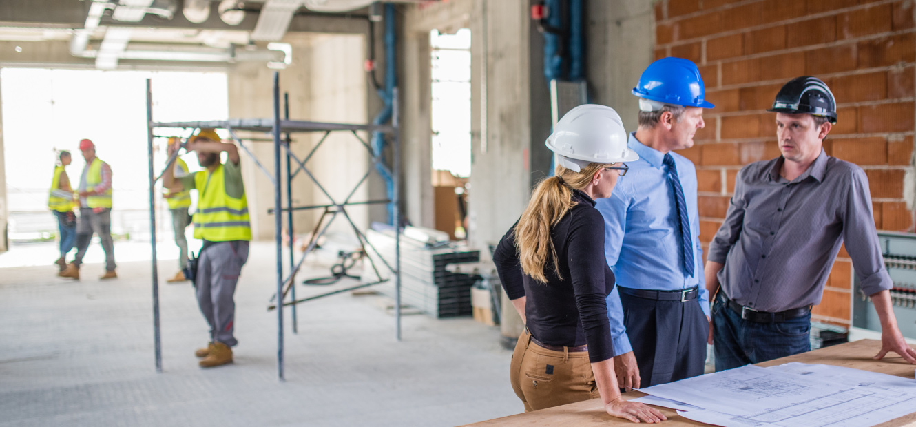 Coworkers standing amidst construction